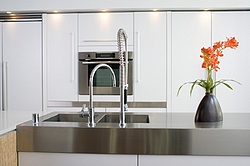 Metal counters offer a clean modern look to this kitchen.